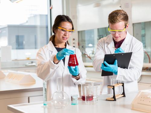 Male and female PhD student working in a science laboratory
