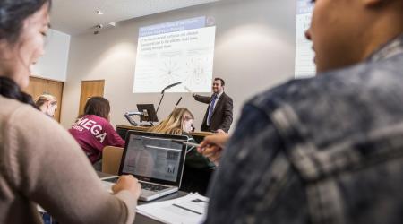 Students listening to a lecturer in a tutorial room