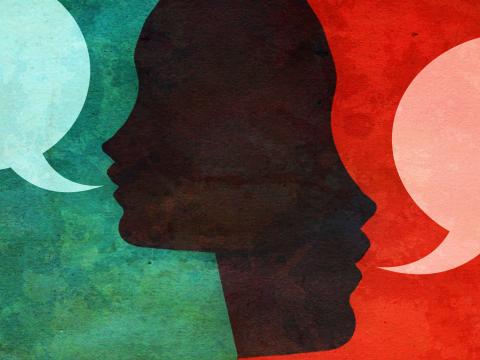 Silhouette of two people's side profiles with speech bubbles emerging from their mouths.